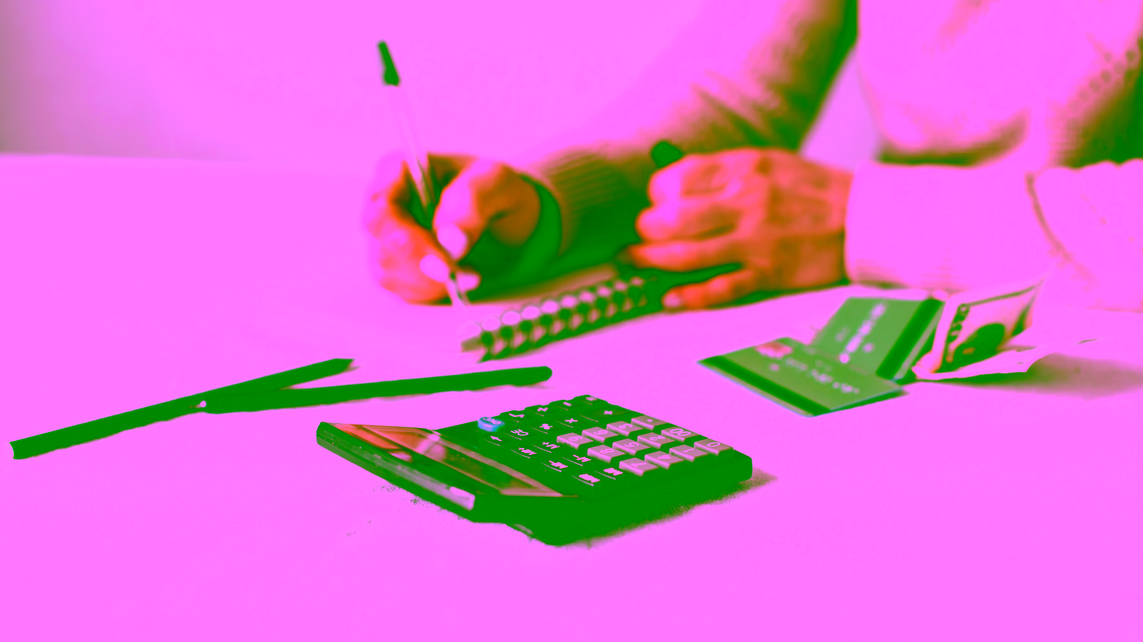 Budgeting with calculator, cash, and credit cards