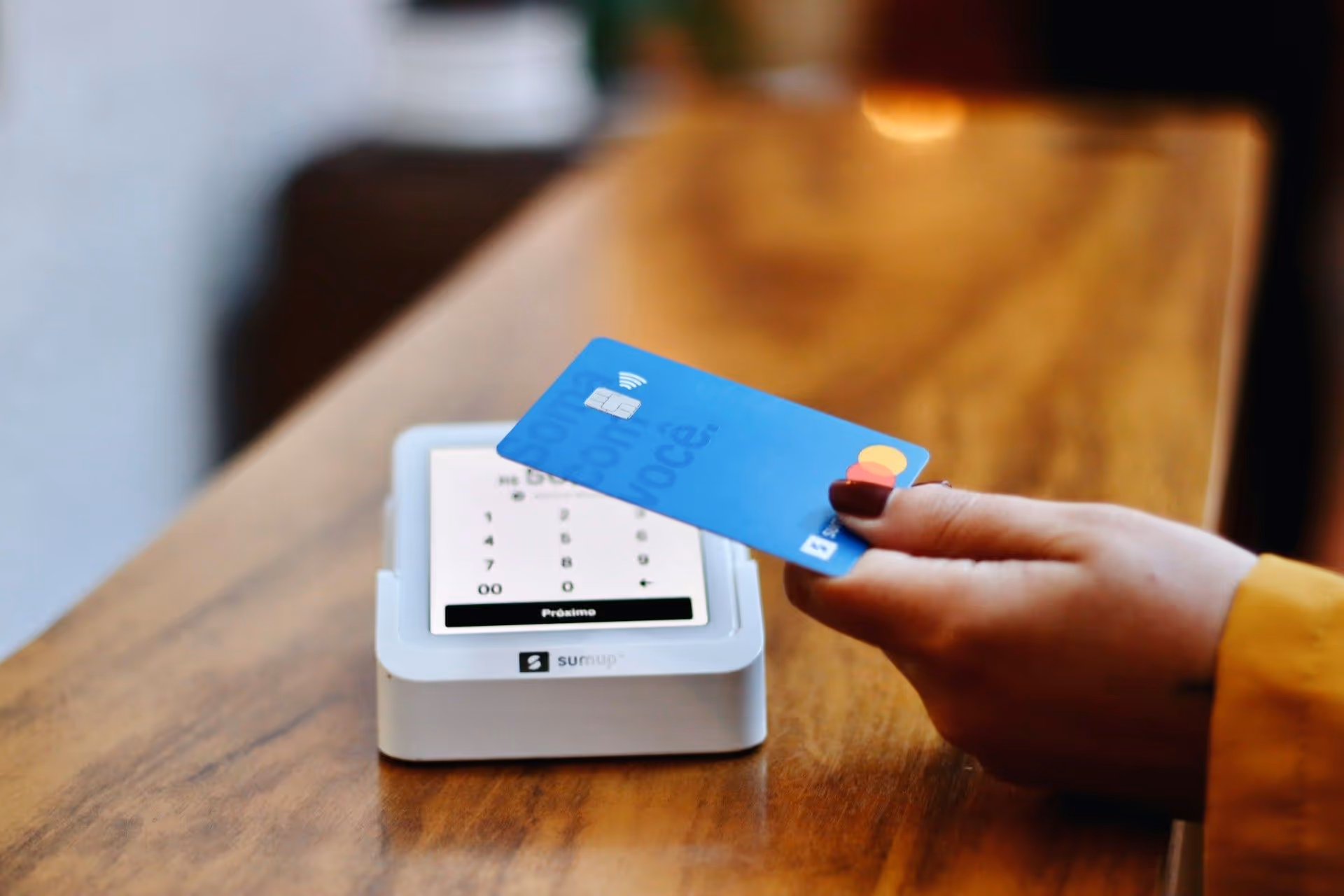 paying with a credit card at a store tap to pay reader