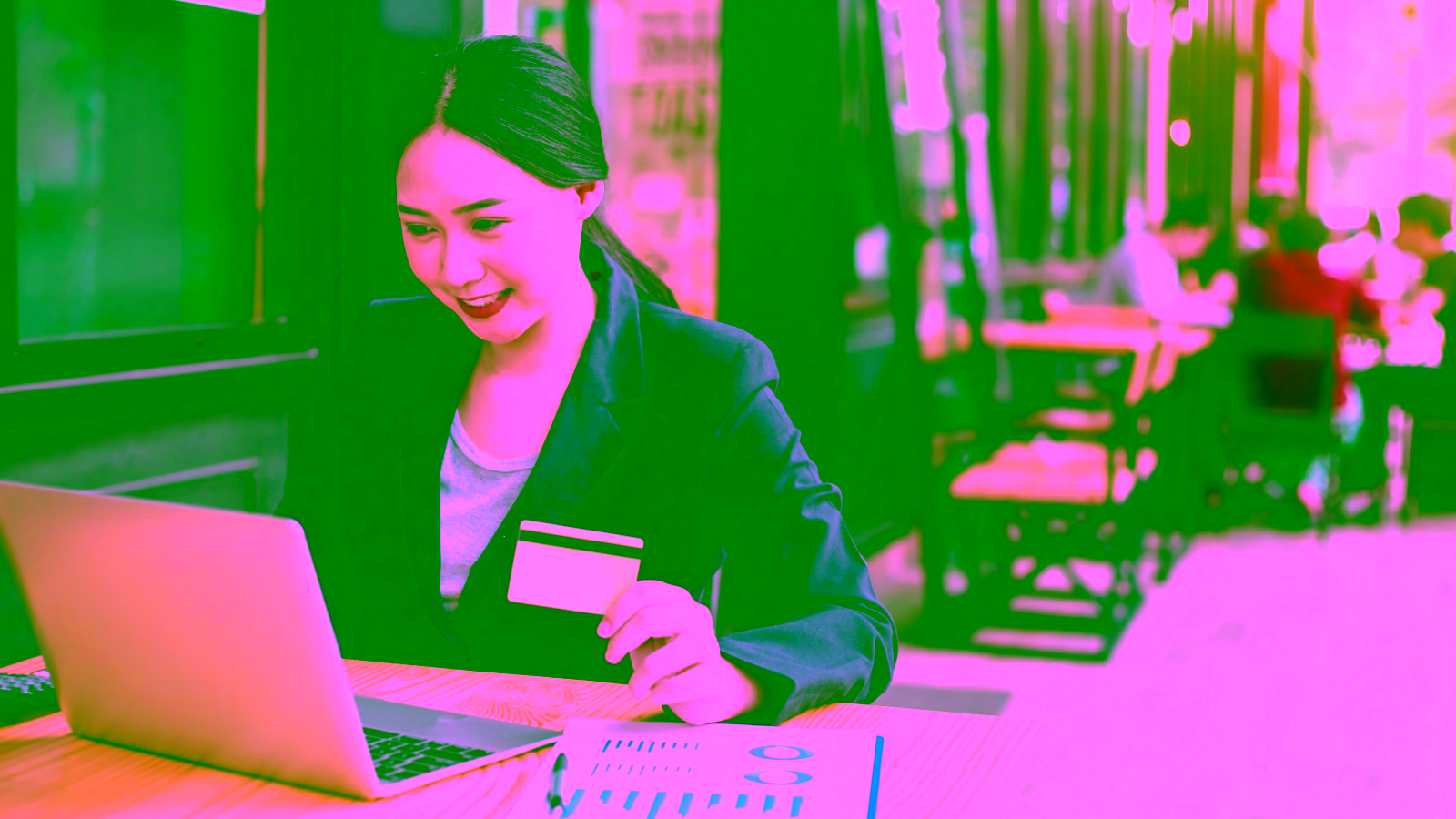 Woman comparing business credit cards at desk