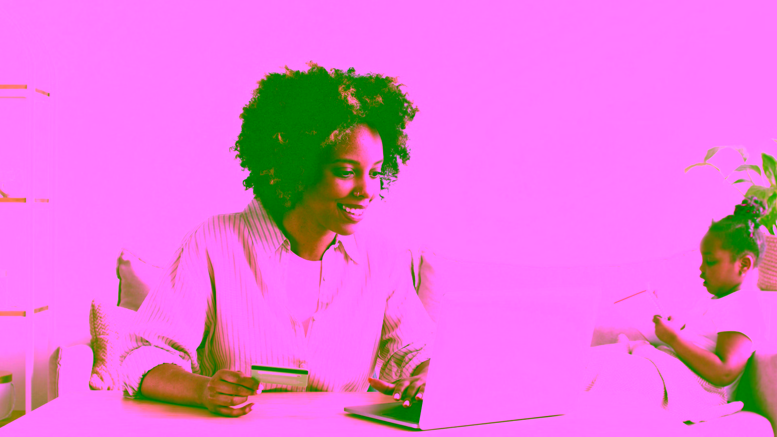 Woman online shopping with a credit card at home