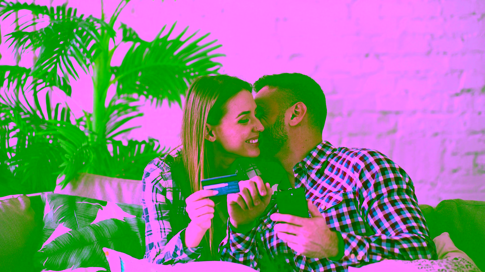 Happy couple using credit card and smartphone