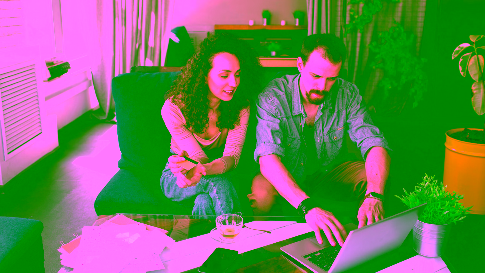 Couple reviewing credit card benefits on laptop at home