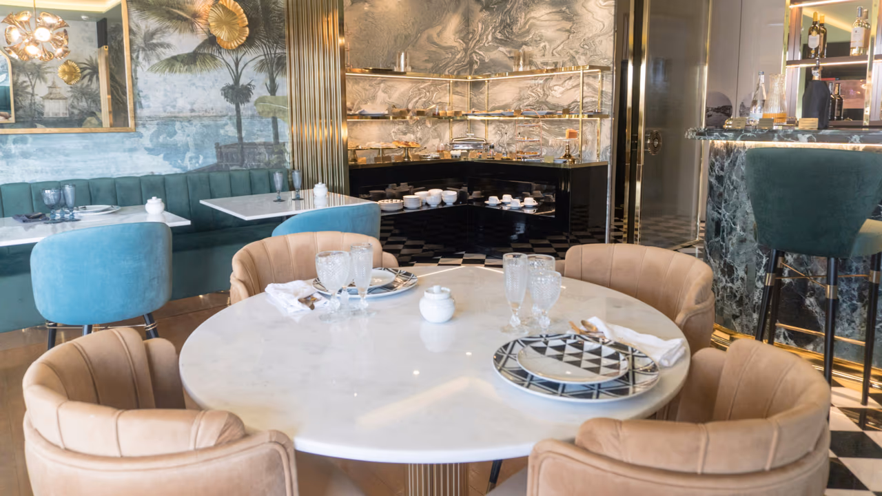 Elegant restaurant interior with marble table and pastel chairs