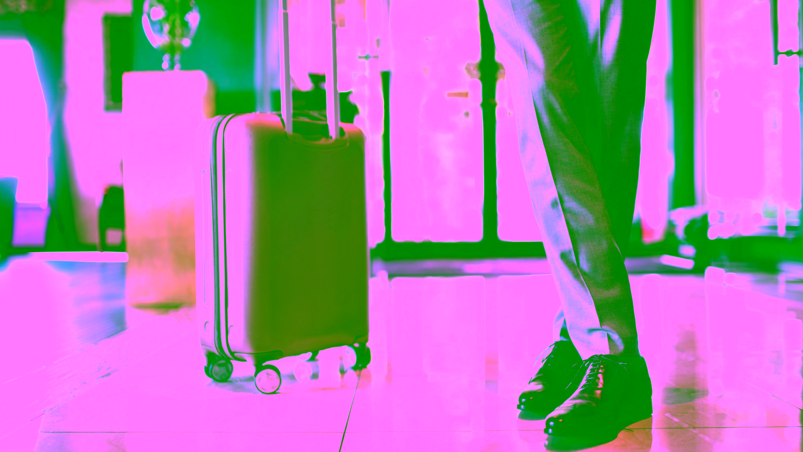 business traveler with suitcase in lobby