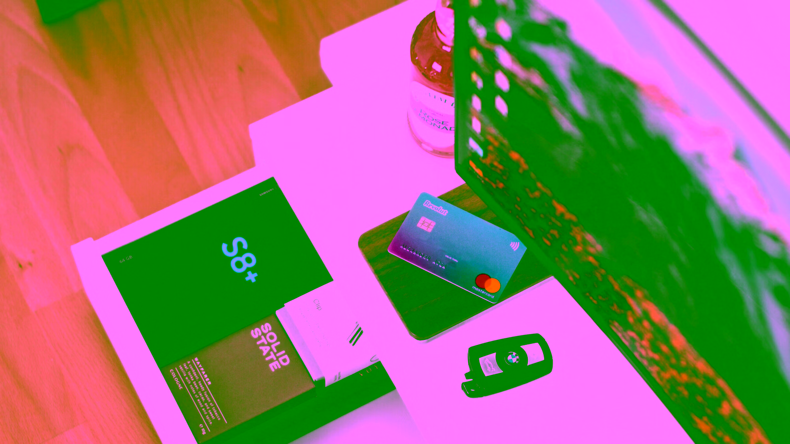 Credit card on desk with laptop and car keys