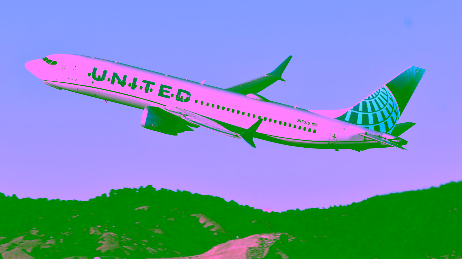 United Airlines plane taking off over hills